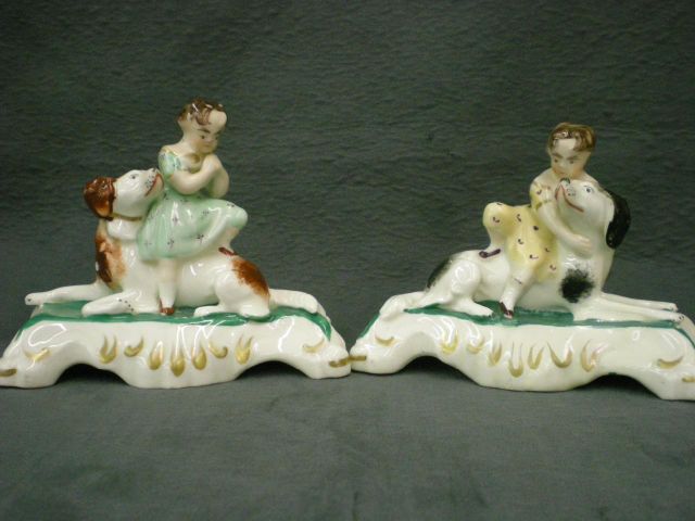 Appraisal: Pair of Staffordshire figures depicting children sitting on the backs