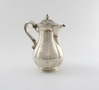 Appraisal: A Victorian silver hot water jug lobed baluster form scroll