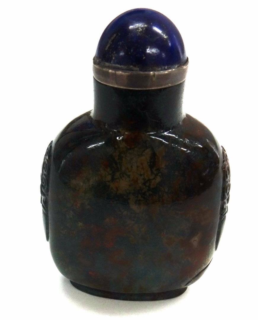 Appraisal: A Chinese carved green and rust speckled quartz snuff bottle