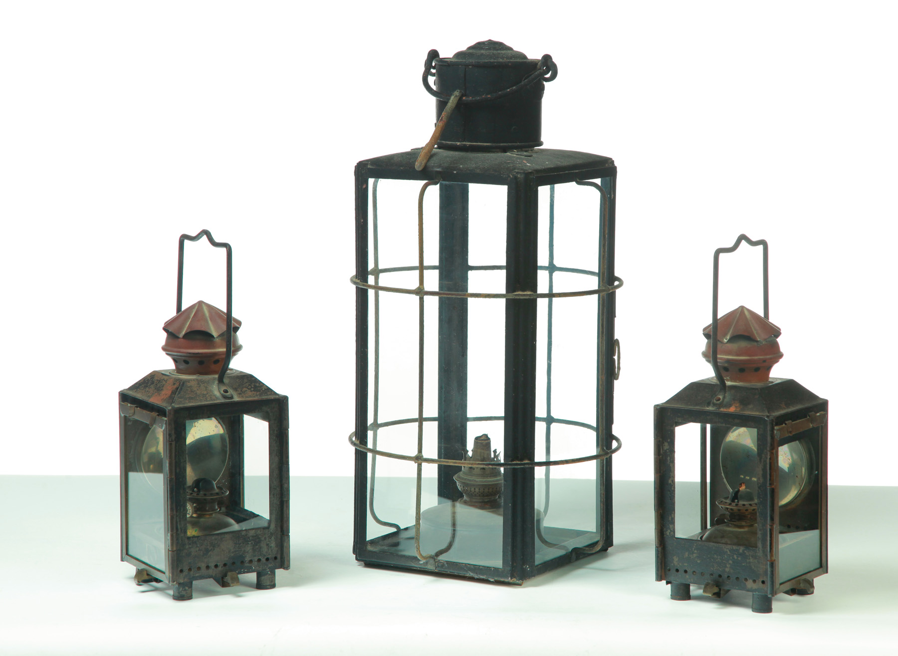 Appraisal: THREE OIL LANTERNS European nd half- th century Tin brass