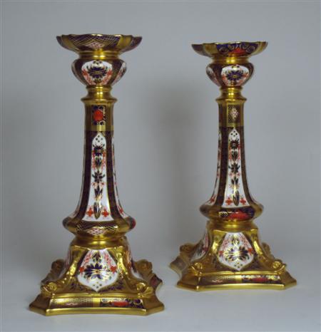 Appraisal: A pair of Royal Crown Derby bone china candlesticks decorated