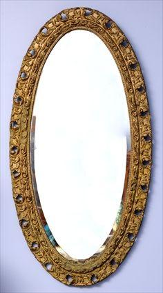 Appraisal: VICTORIAN GILTWOOD WALL MIRROR The oval beveled mirror plate in