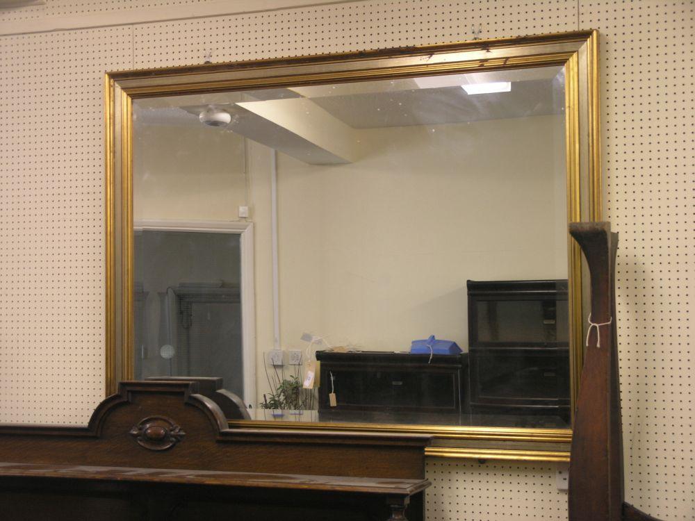 Appraisal: A large gilt framed hall mirror with bevelled plate ft