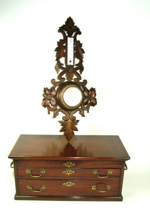 Appraisal: A two door mahogany cabinet with rising top containing drawing