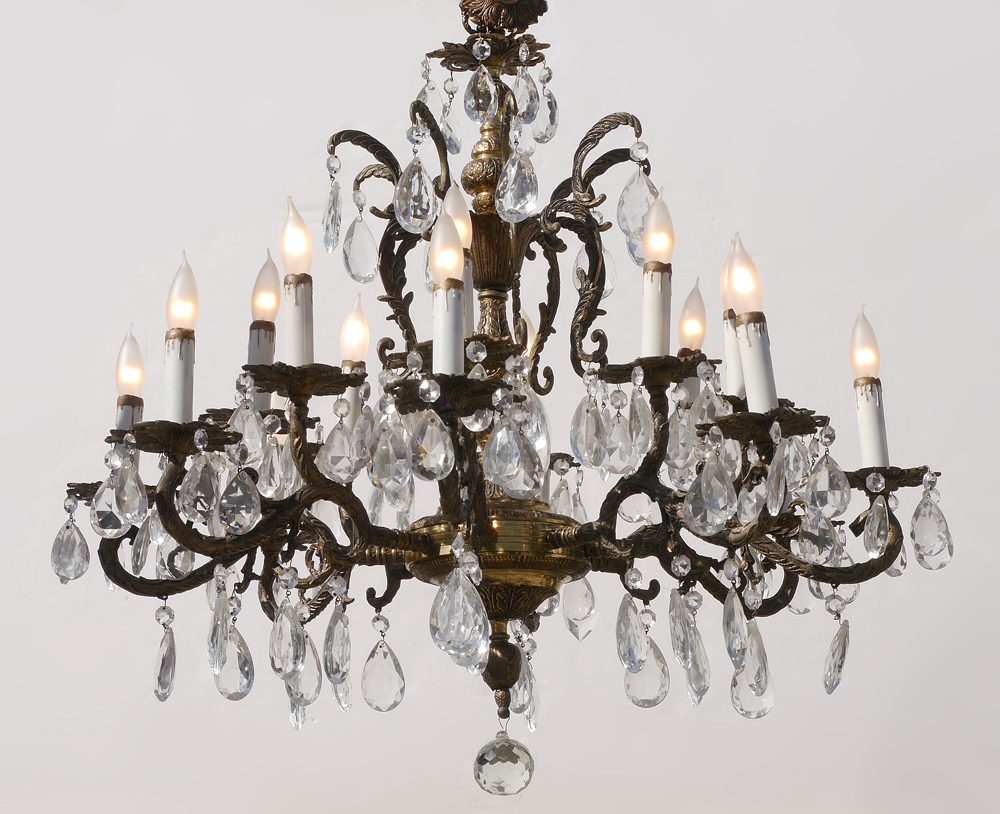 Appraisal: LIGHT BRASS CRYSTAL CHANDELIER Brass foliate design arm chandelier with