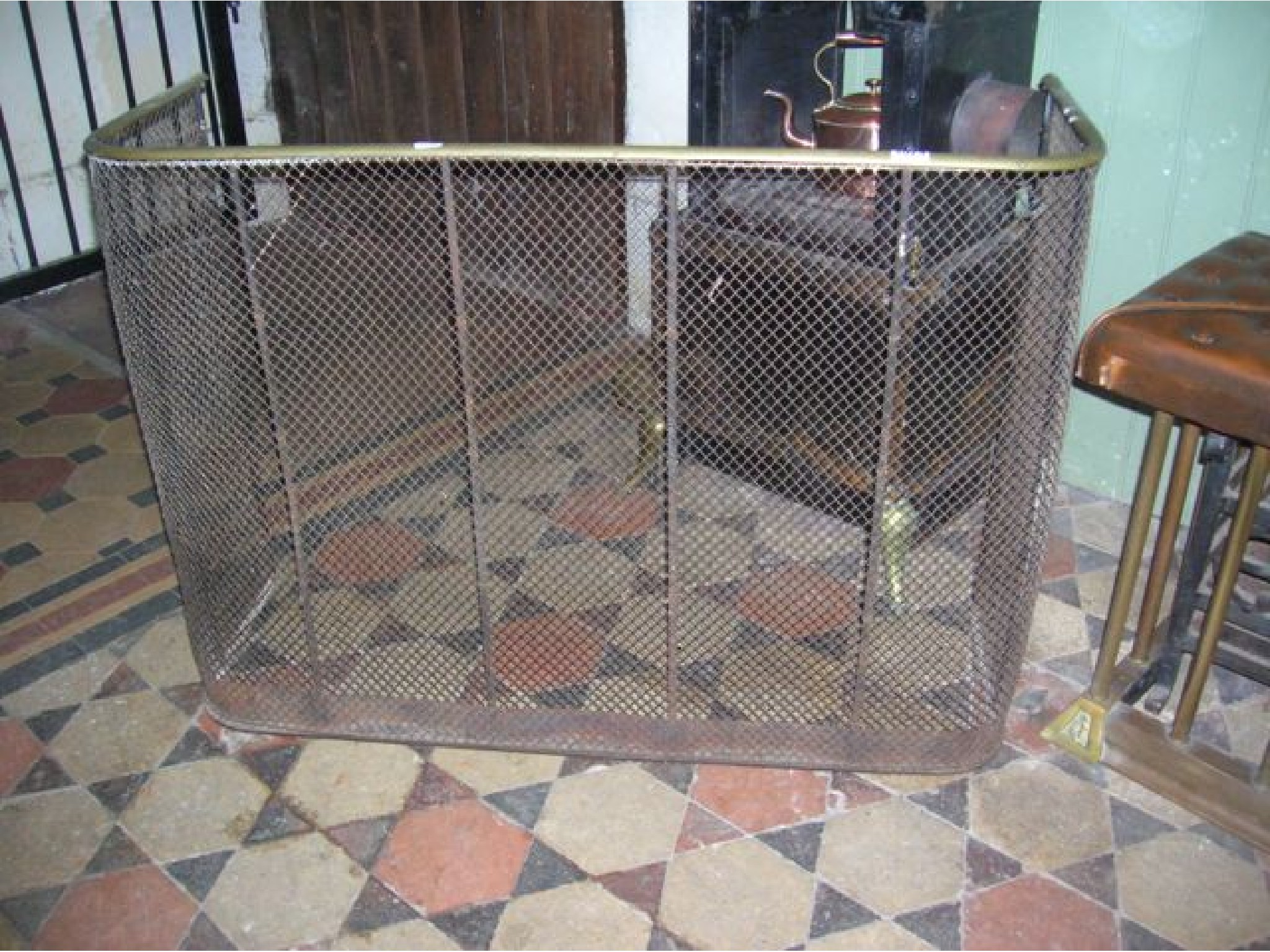 Appraisal: A Victorian wirework fender nursery guard with brass top rail