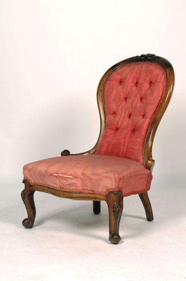 Appraisal: A VICTORIAN WALNUT FRAMED BUTTON BACK NURSING CHAIR the shaped