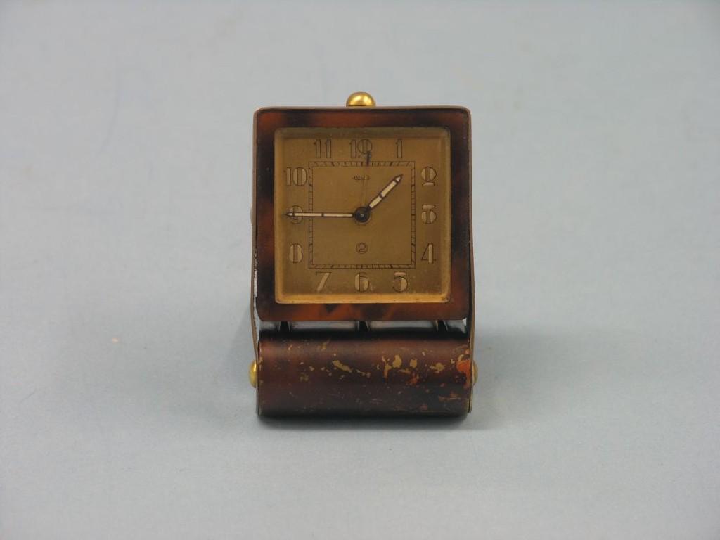 Appraisal: A Jaeger travelling alarm clock with square gilt-metal dial in