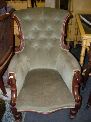 Appraisal: A Victorian green upholstered chair the shaped button back above