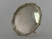 Appraisal: A shaped circular salver with ribbon and reed border on