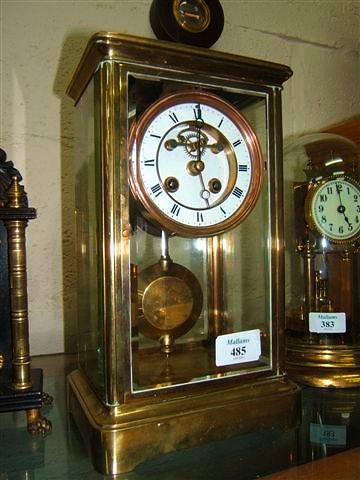 Appraisal: A French brass four glass mantel clock with white enamel