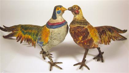 Appraisal: Two cold-painted metal pheasantsEach modelled standing painted in vibrant hues