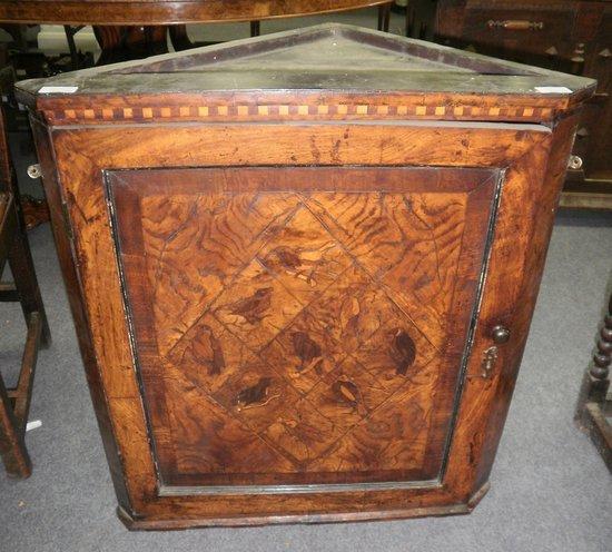 Appraisal: An th Century walnut and inlaid corner cupboard the door