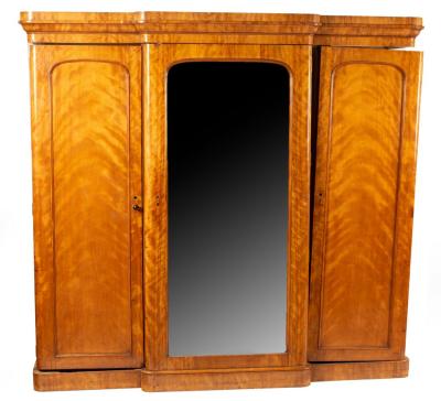 Appraisal: A Victorian satinwood breakfront triple wardrobe the central mirrored door