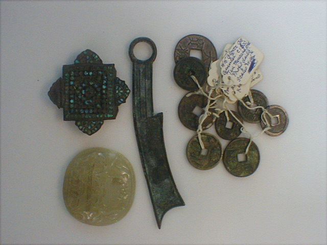 Appraisal: A Tibetan amulet Chinese coins and jade plaque from a