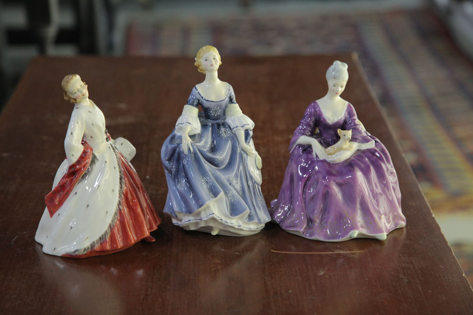 Appraisal: THREE ROYAL DOULTON FIGURES English th century Hilary HN ''h