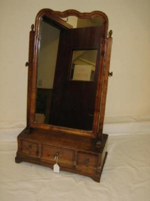 Appraisal: A WALNUT TOILET MIRROR of early Georgian design the arched