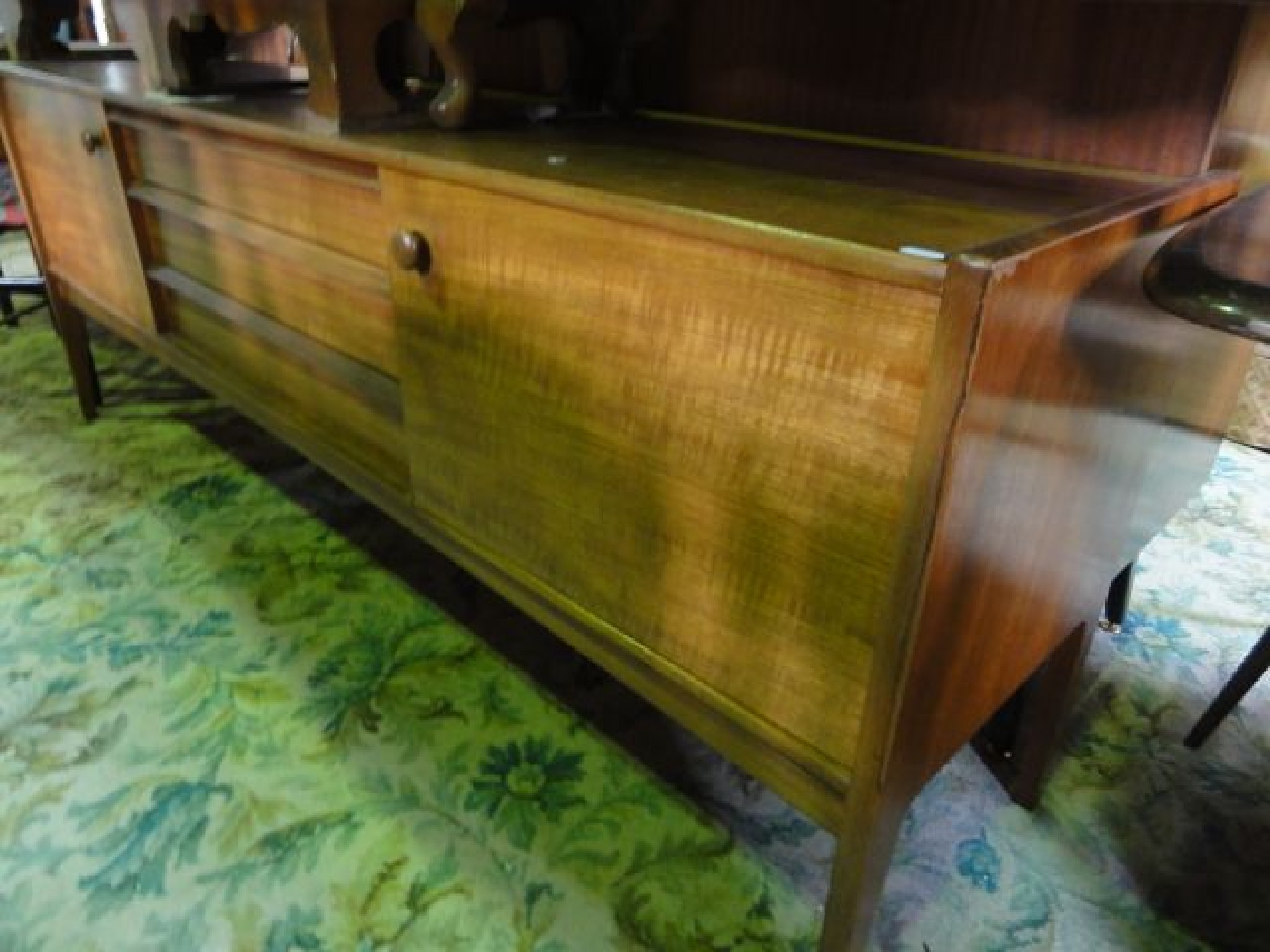 Appraisal: A long and low mid- th century teak sideboard fitted