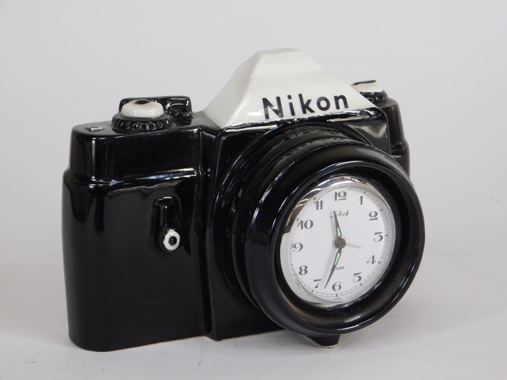 Appraisal: NIKON CAMERA ADVERTISING CLOCK Nikon camera shaped ceramic advertising clock