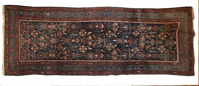 Appraisal: A PERSIAN BLUE GROUND RUG with central panel of foliate