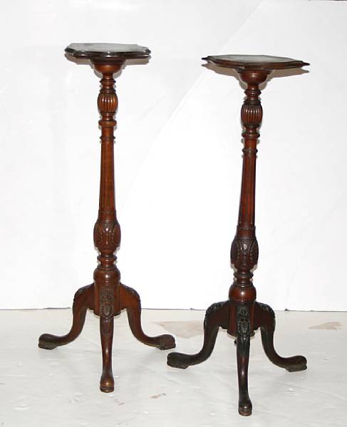 Appraisal: A pair of George III style mahogany pedestal urn stands