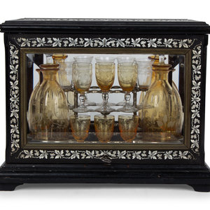 Appraisal: A French Ebonized and Inlaid Cave Liqueur with Amber Glass