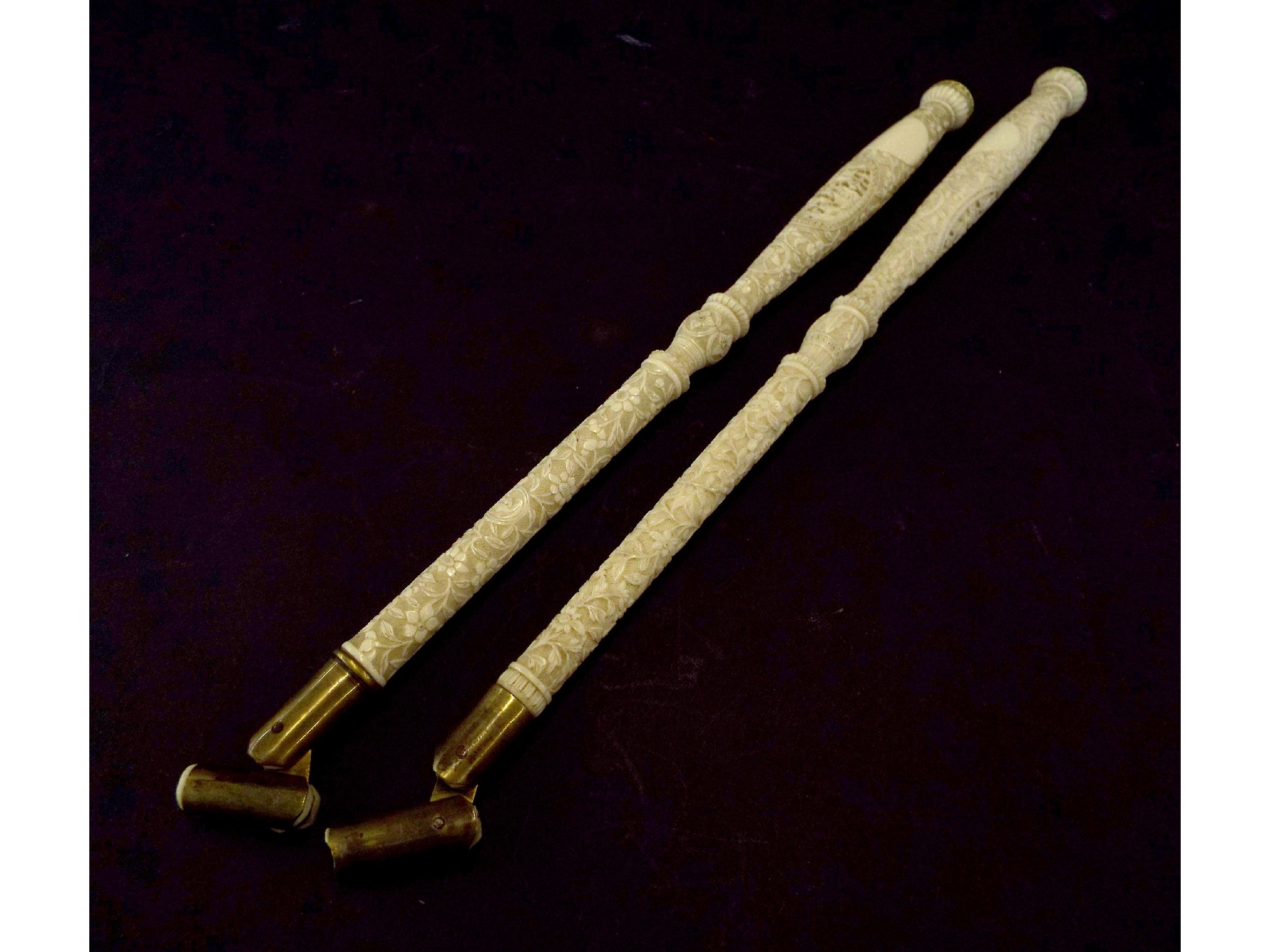 Appraisal: Pair of carved ivory parasol handles decorated with panels of