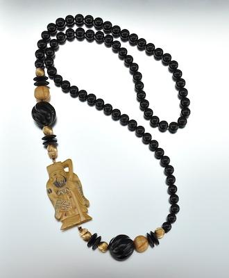 Appraisal: A Carved Netsuke and Onyx Bead Necklace Carved ivory netsuke