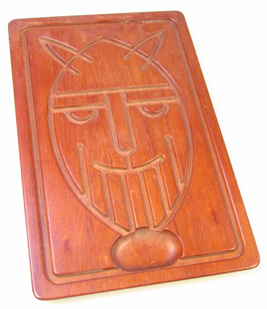 Appraisal: A 's Danish teak panel board decorated with face mask