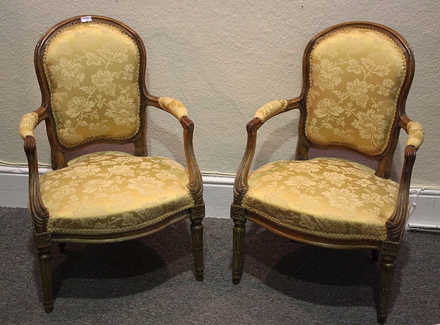 Appraisal: A PAIR OF FRENCH TRANSITIONAL BEECHWOOD FAUTEUILS with later silk