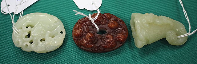 Appraisal: AN ORIENTAL POSSIBLY JADE PENDANT together with a small carved