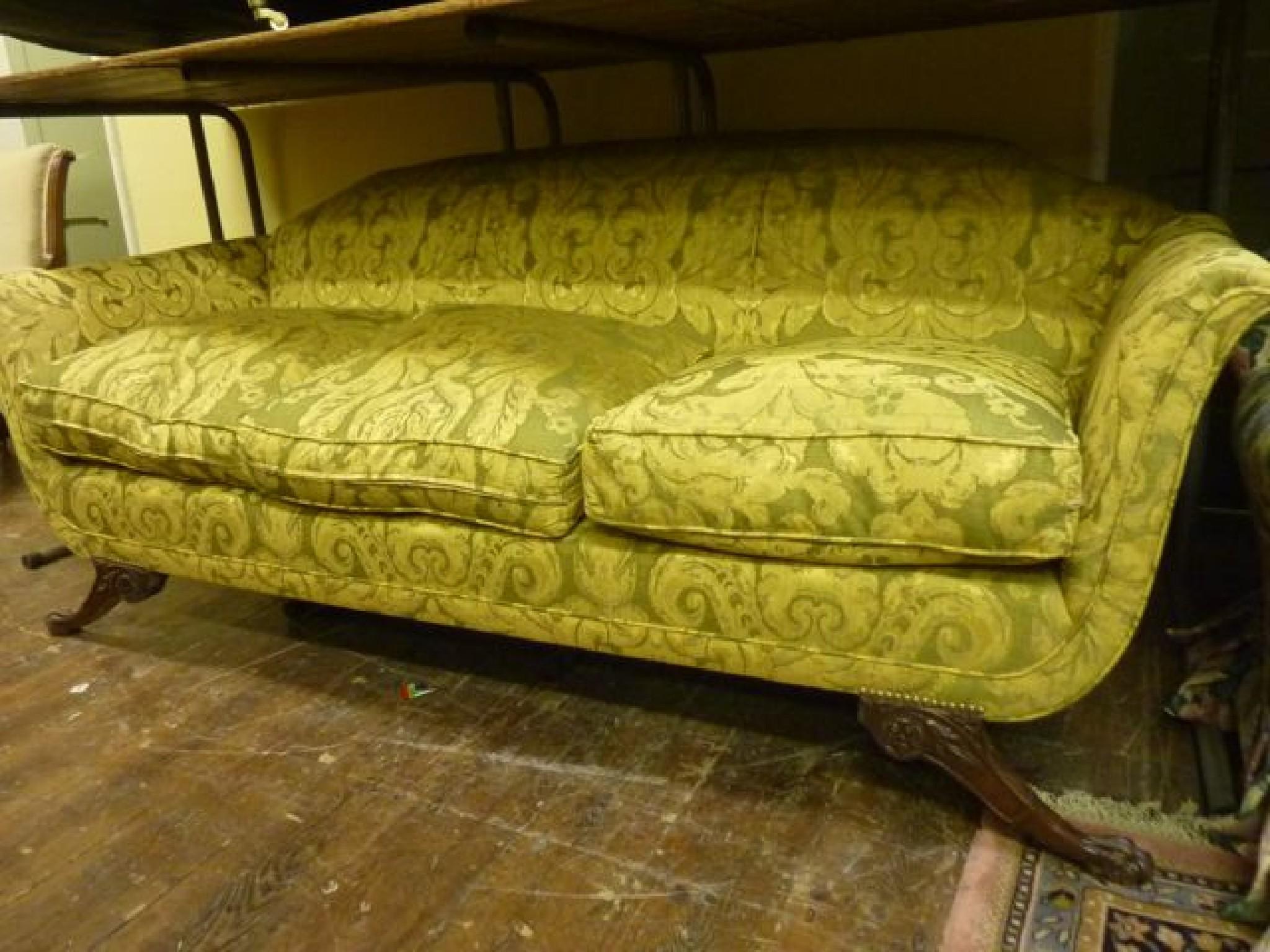 Appraisal: A Regency style three seat sofa with shaped outline upholstered