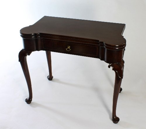 Appraisal: A George I Irish card table with fold-over shaped top