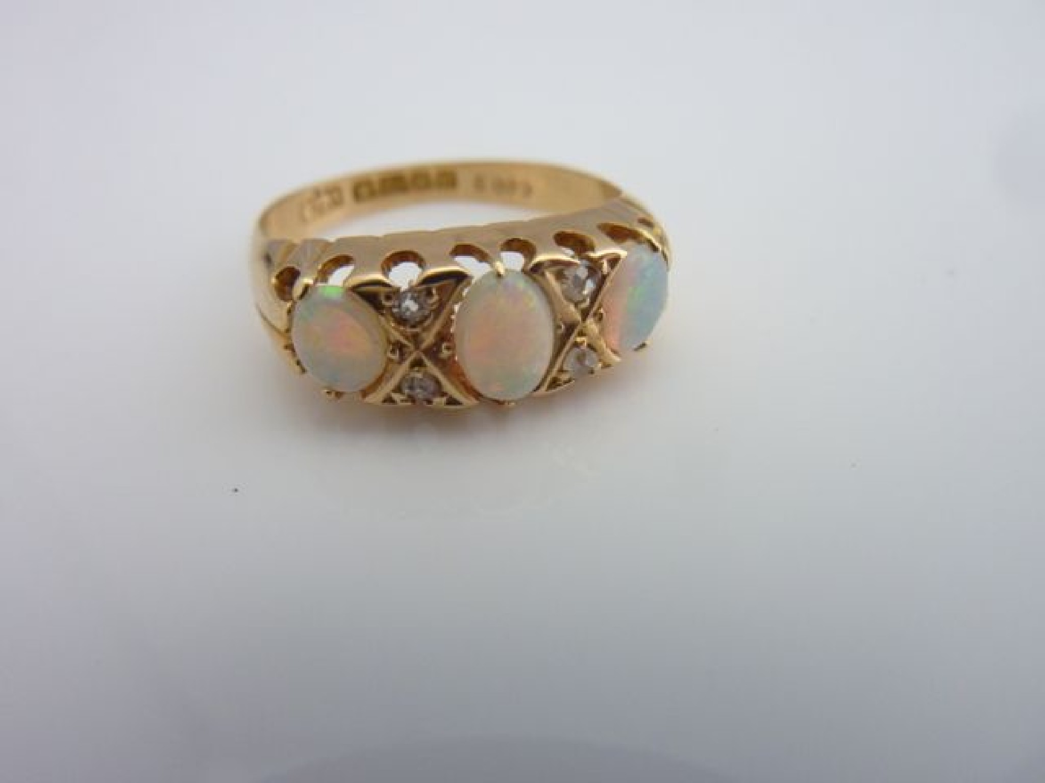 Appraisal: An opal and diamond ring Birmingham set with three graduated