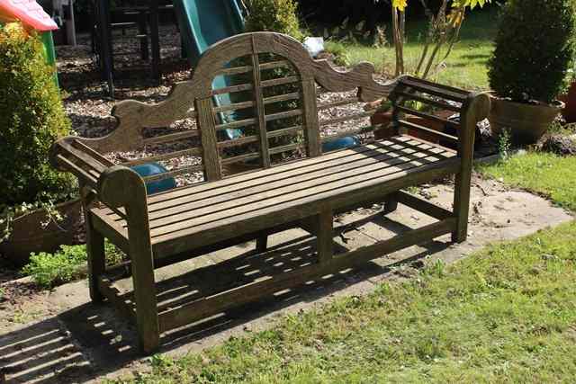 Appraisal: A TEAK LUTYENS STYLE GARDEN SEAT with camel back and