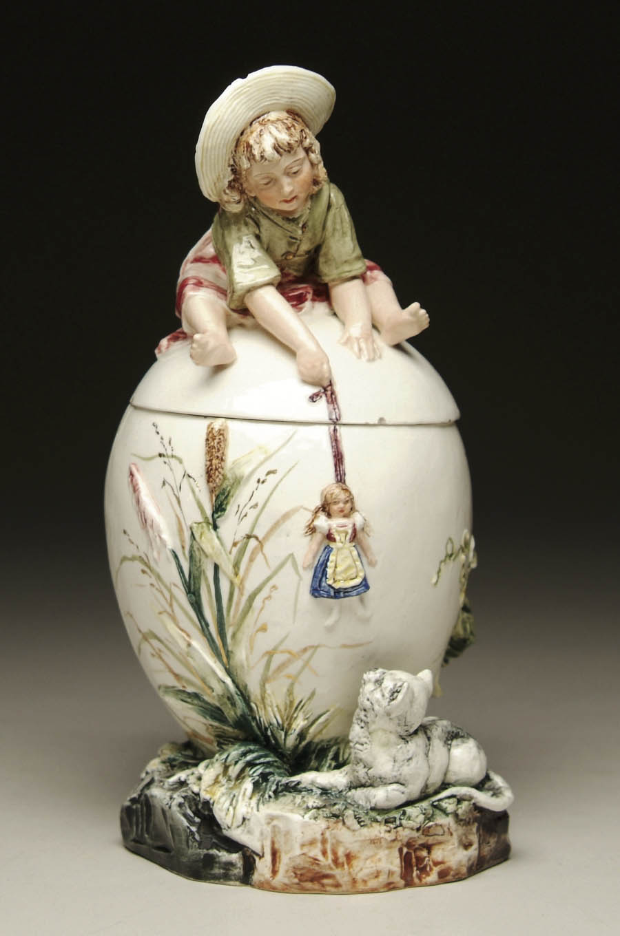 Appraisal: CHARMING EGG-SHAPED MAJOLICA HUMIDOR Lid with figural straw-bonneted playful child