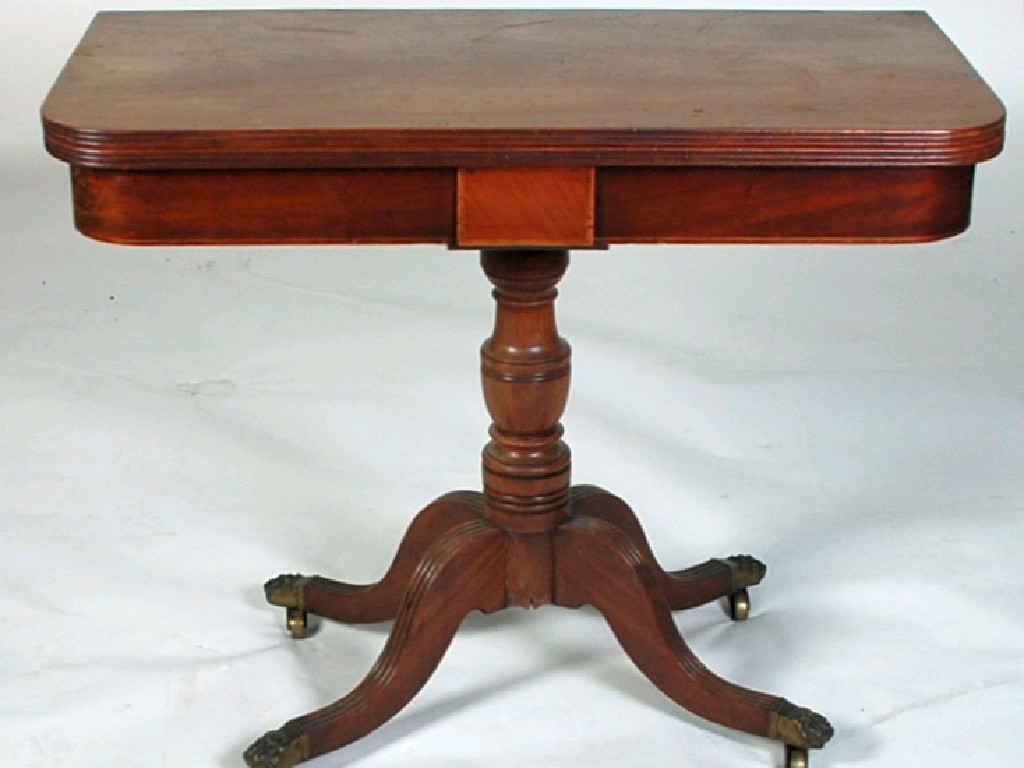 Appraisal: GEORGIAN MAHOGANY FOLD OVER PEDESTAL TEA TABLE the reeded oblong