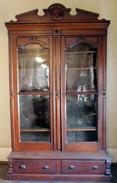 Appraisal: Massive Victorian carved walnut bookcase with two glass doors over