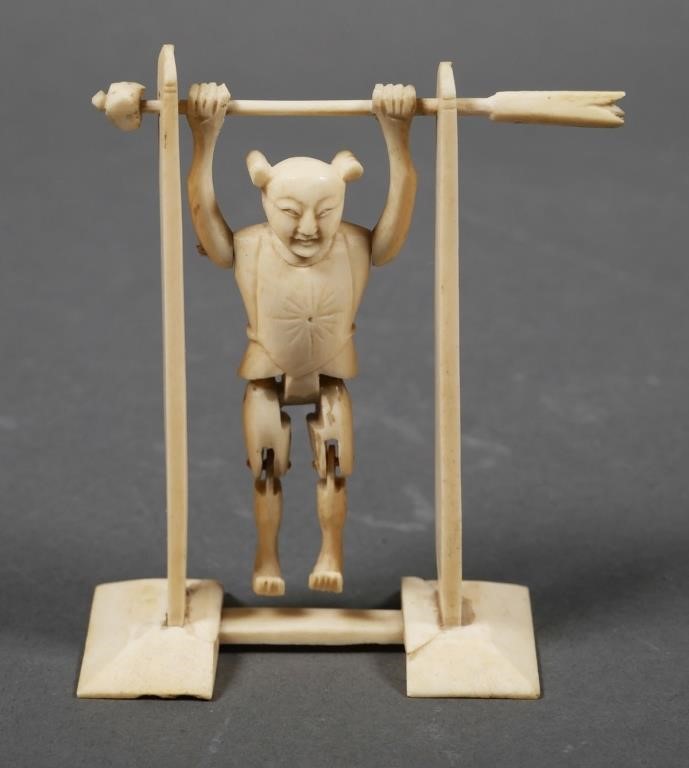 Appraisal: Antique carved ivory jointed acrobat holding crossbar Turning either end