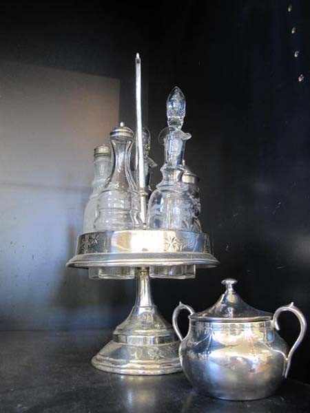 Appraisal: SILVER PLATE FIVE BOTTLE CRUET SET AND SUGAR VESSEL