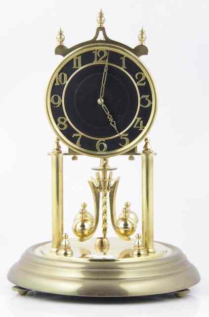 Appraisal: A -day brass mounted clock under a glass dome cm