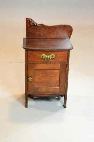 Appraisal: SMALL NIGHT STAND WITH CARVED SPLASHUnusual mahogony cabinet or night