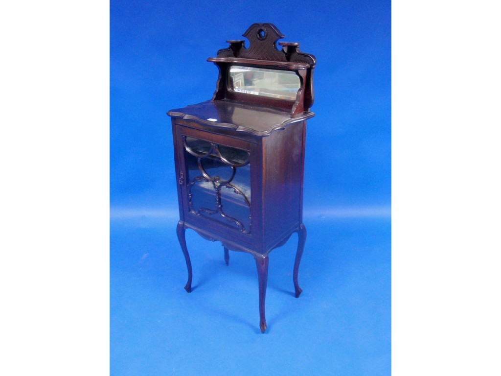 Appraisal: A late Victorian ebonised display cabinet with low mirror back