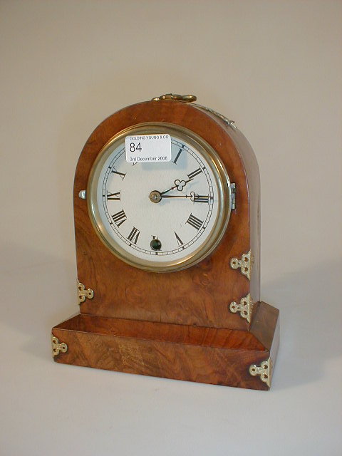 Appraisal: A Victorian figured walnut mantel clock