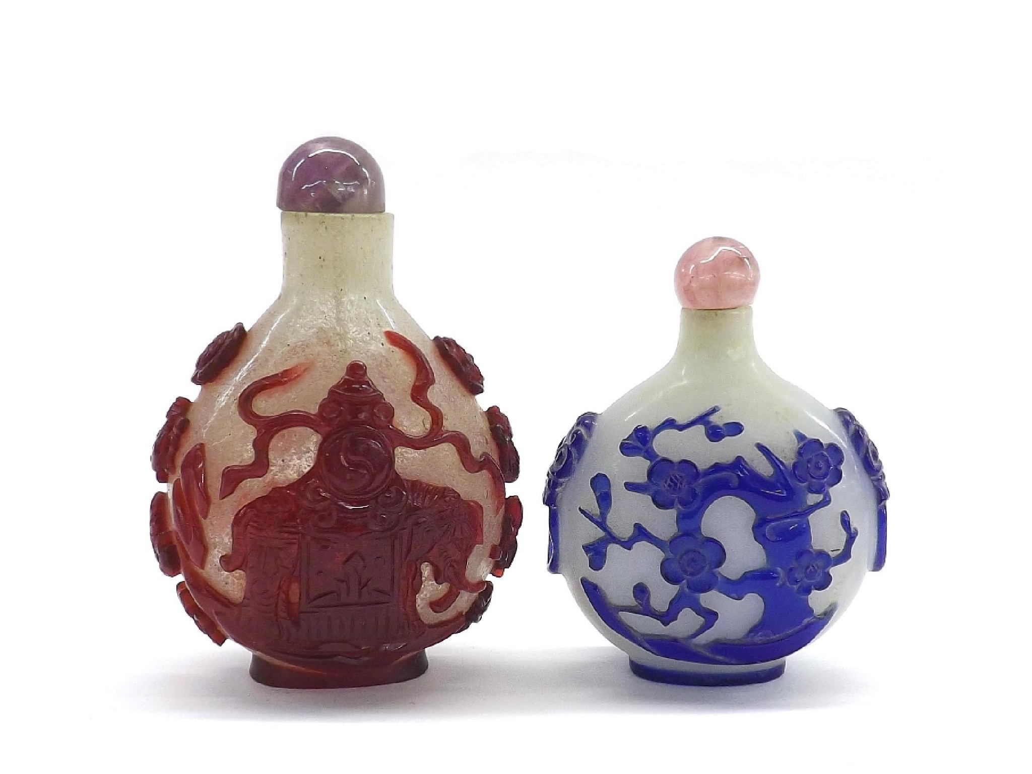 Appraisal: Two glass snuff bottles one decorated in relief with an