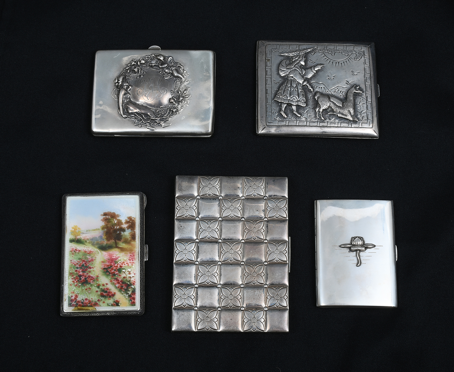 Appraisal: PC SILVER CIGARETTE CASES Comprising - Evans case with floral