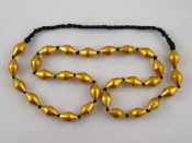 Appraisal: A necklace comprising black cotton and yellow metal tests high