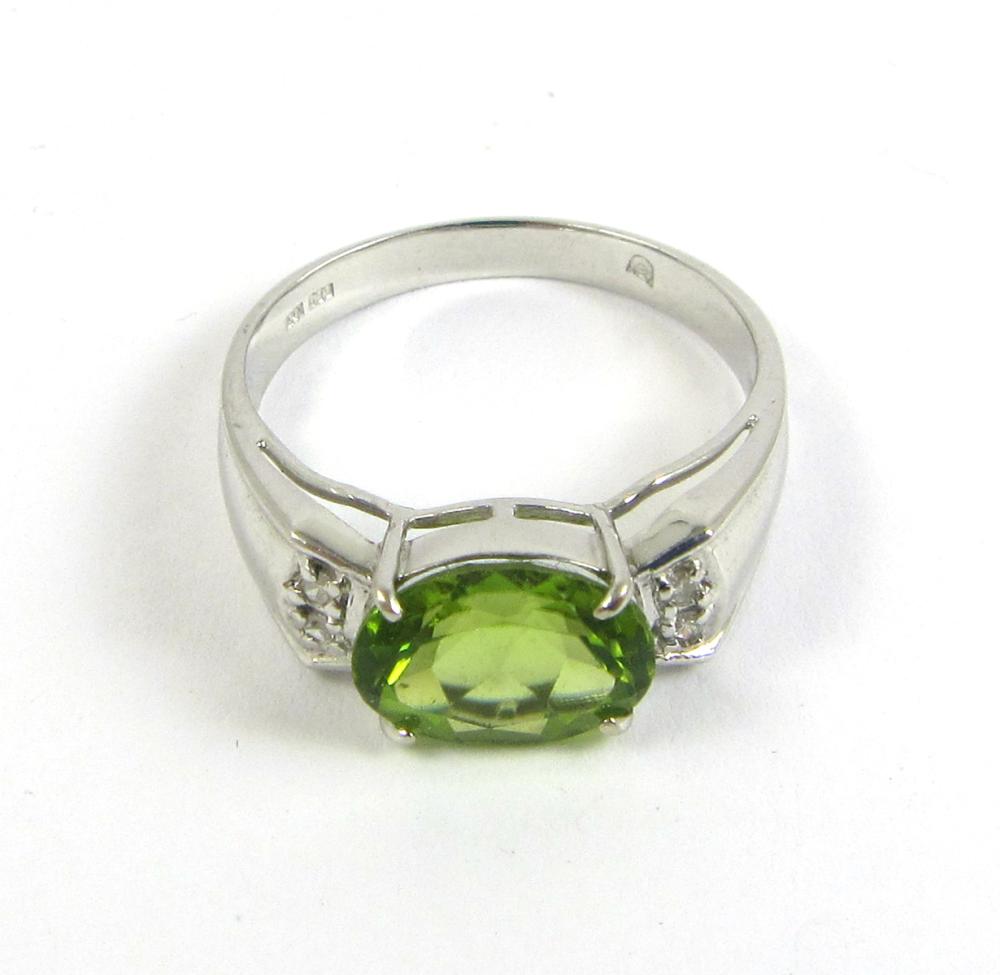 Appraisal: PERIDOT DIAMOND AND FOURTEEN KARAT GOLD RING The k white