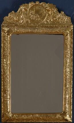 Appraisal: REGENCE-STYLE GILT REPOUSS METAL MIRROR The frame with cherubs amidst