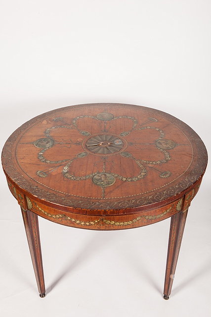 Appraisal: AN EDWARDIAN SHERATON REVIVAL CIRCULAR SATINWOOD AND PAINTED CENTRE TABLE